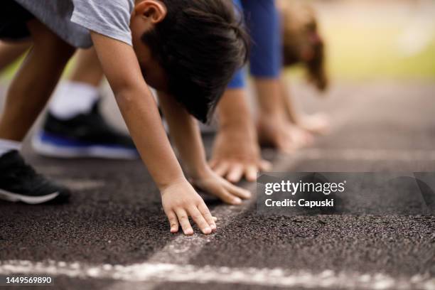 close up of a kid hand on a sprint position at the starting line - race 8 stock pictures, royalty-free photos & images