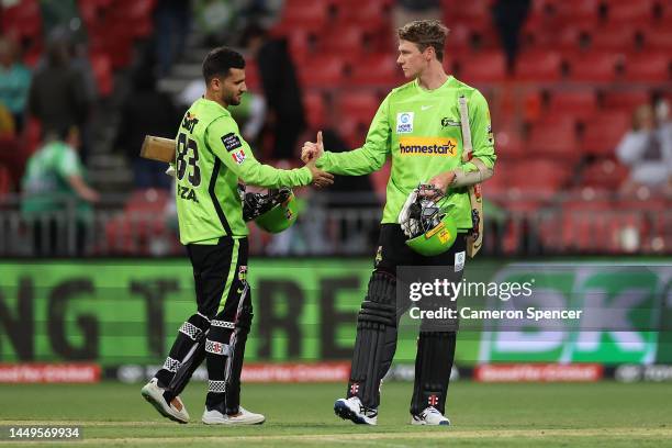 Fazalhaq Farooqi of the Thunder and Brendan Doggett of the Thunder shake hands after losing the Men's Big Bash League match between the Sydney...