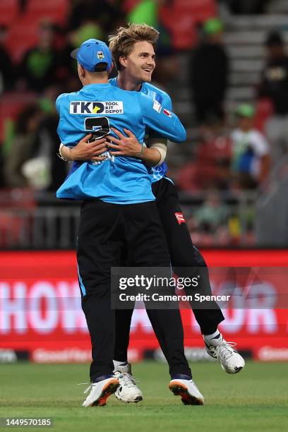 Henry Thornton of the Strikers celebrates with Matt Short of the Strikers after dismissing Brendan Doggett of the Thunder and winning the Men's Big...