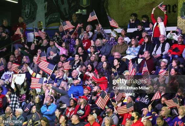 Fans wave American flags during a break in the second period of a Rivalry Series game between Team Canada and Team United States at The Dollar Loan...