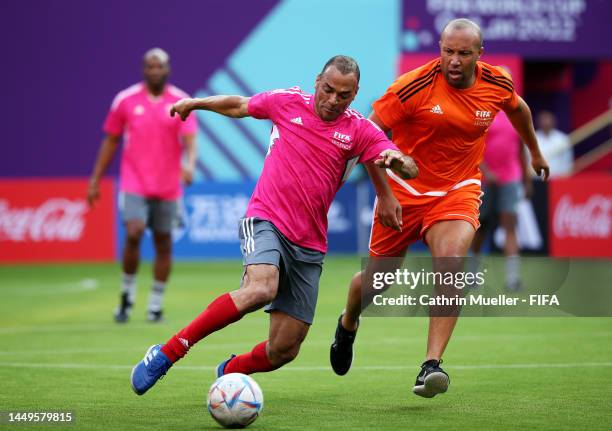 Cafu runs with the ball under pressure from Mikael Silvestre during day 2 of the FIFA Legends Cup at Khalifa International Tennis and Squash Complex...