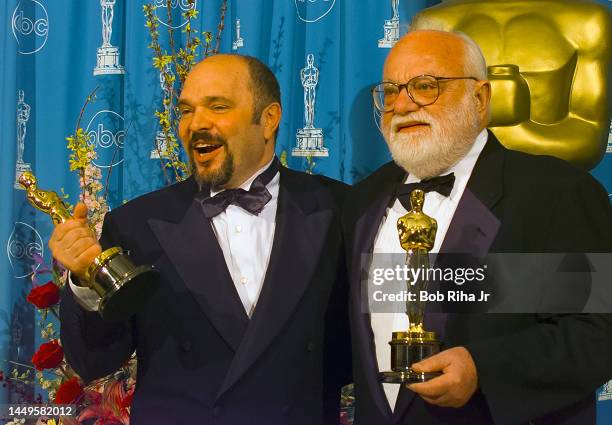 Oscar Winners Director Anthony Minghella and producer Saul Zaentz hold the Oscars they won for Best Director and Best Picture at Academy Awards,...