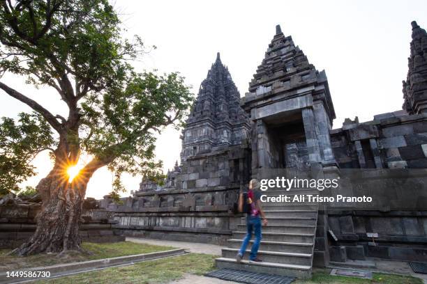 sunset, blurred tourist moving up the ladder, magnificent prambanan temple, yogyakarta - unesco world heritage site stock pictures, royalty-free photos & images