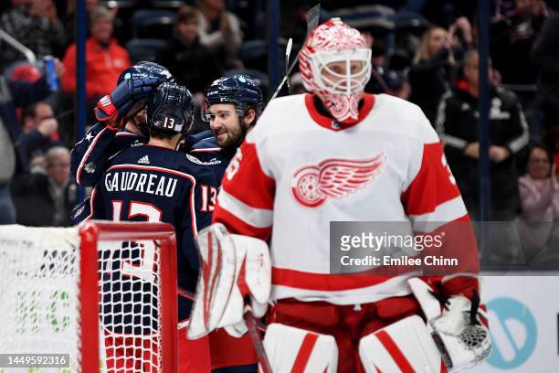 Boone Jenner, Johnny Gaudreau and Emil Bemstrom of the Columbus Blue Jackets celebrate a goal during the second period against the Detroit Red Wings...