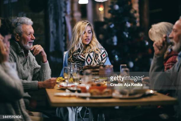 family having dinner outdoors in their back yard. - people family group sad stock pictures, royalty-free photos & images