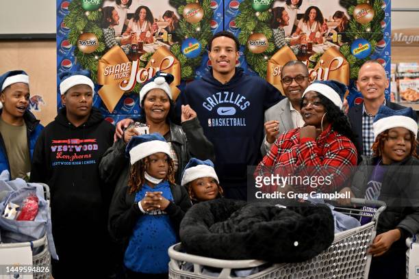 Memphis Grizzlies player Desmond Bane, Kroger Delta Division President Micheal Cristal, and PepsiCo Sales Director Nelson Goncalves greet families as...
