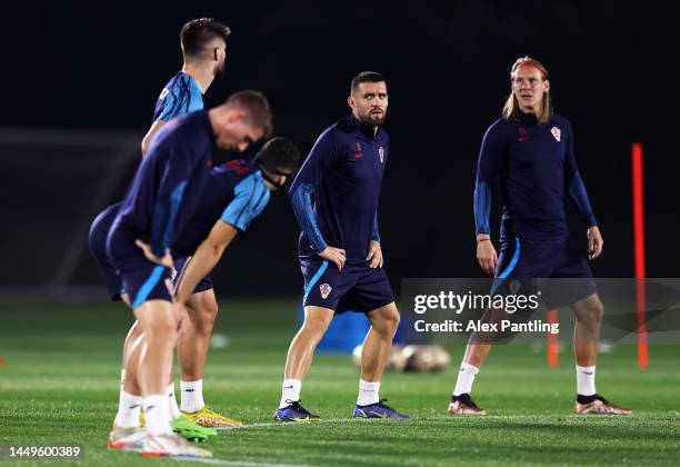 Mateo Kovacic of Croatia looks on with teammates during the Croatia Training Session on match day -1 at on December 16, 2022 in Doha, Qatar.