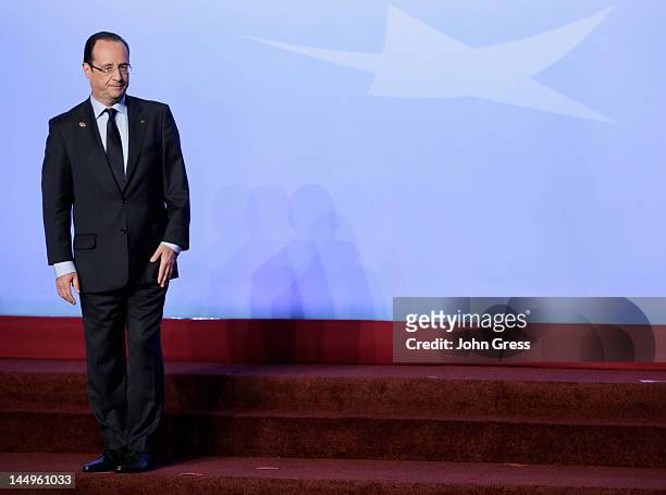 French President Francois Hollande leaves the stage after posing for a group photo during the NATO summit on May 21, 2012 at McCormick Place in...