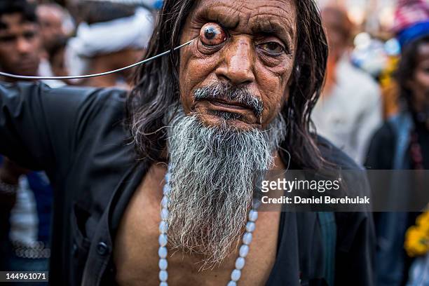 Sufi Muslim pilgrim, Kale Baba who walked for 13 days from New Delhi as part of the pilgrimage, self-flagellates during a procession on May 21, 2012...