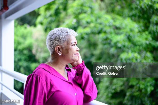 a middle-aged woman looking away to the trees - systemic lupus erythematosus stock pictures, royalty-free photos & images