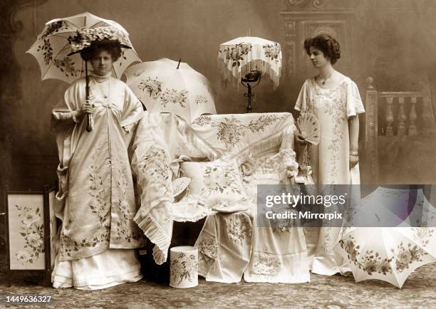 Edwardian mannequins model hand painted silk gowns at the Daily Mirror Fair of Fashion show Models wearing Edwardian clothes holding parasolsMay 1909.