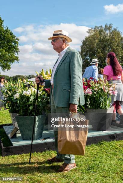 Gentleman wearing country style cloths including Panama hat and cane stands among the visitors on the first day of the Autumn Harrogate Flower Show...