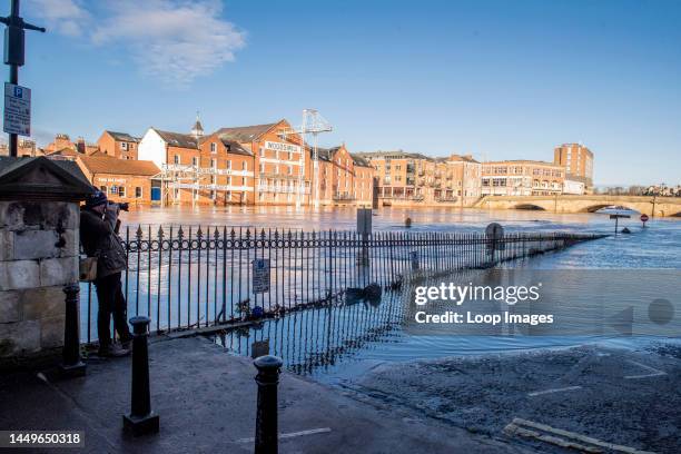 Photographer takes a picture of areas by the river Ouse in the centre of York which are flooded after heavy rains.