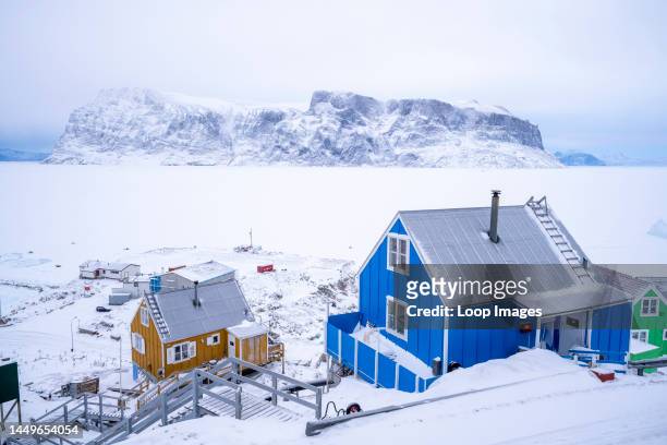 Colourful houses overlooking the sea ice at Uummannaq in west Greenland.