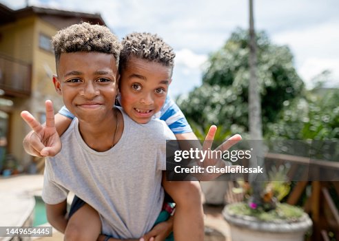 Smiling young brothers playing together outside in summer Smiling young brothers playing together outside in summer