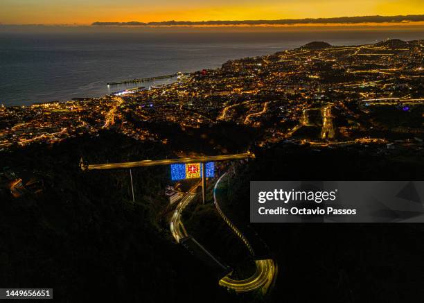 An overview of the city of Funchal at night on December 16, 2022 in Funchal, Madeira, Portugal. Madeira is a Portuguese island in the Atlantic Ocean,...