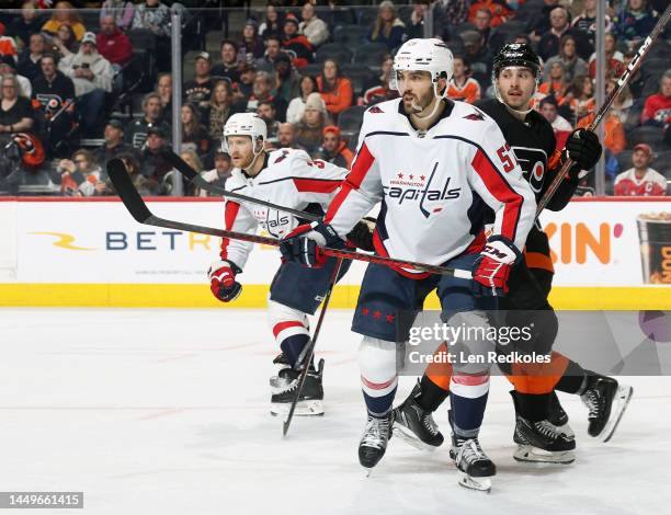 Trevor van Riemsdyk and Nick Jensen of the Washington Capitals defend Noah Cates of the Philadelphia Flyers at the Wells Fargo Center on December 7,...