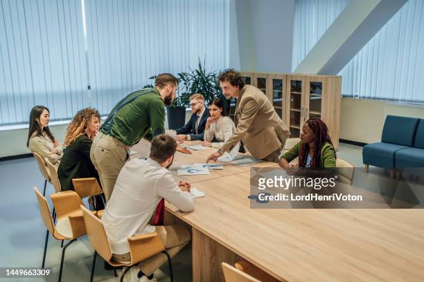 businessman arguing with his colleague at a meeting - fighting group stock pictures, royalty-free photos & images