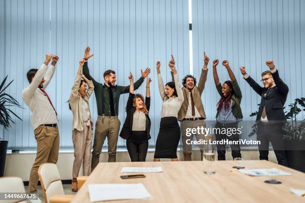 office workers celebrating financial success - good news stock pictures, royalty-free photos & images