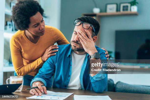 couple doing their budget at home - hopelessness stock pictures, royalty-free photos & images