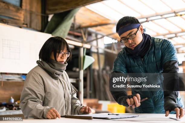 young carpenter processing materials for wooden house construction. - cryptomeria japonica stock pictures, royalty-free photos & images