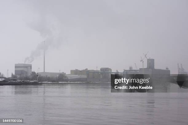 General view of the Tilbury Green Power Plant and ADM Milling UK flour mill on a foggy day beside the Thames River on December 12, 2022 in Grays,...