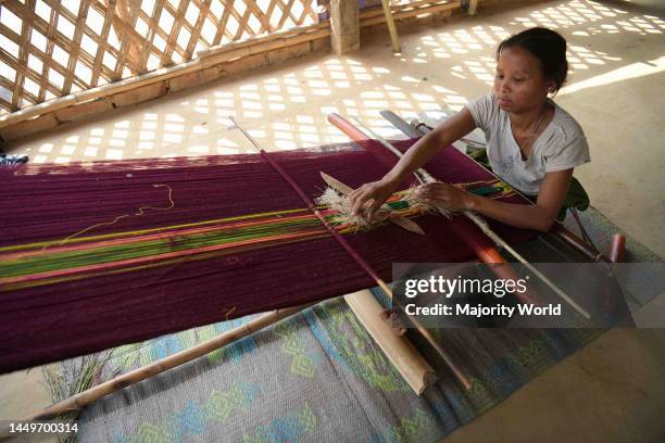 Tribal woman weaving 'Rignawi', a traditional cloth used by the tribes of Tripura, in Tirthamoni village. Agartala, Tripura, India.