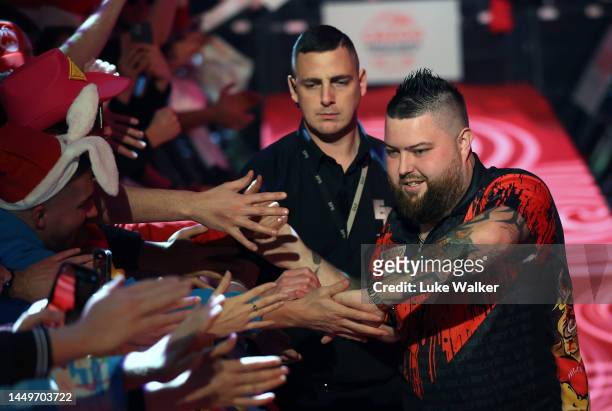 Michael Smith of England walks on during his Second Round match against Nathan Rafferty of Northern Ireland during Day Two of The Cazoo World Darts...