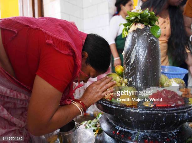 Hindu devotees offer prayers at a temple of Lord Shiva on the occasion of Maha Shivratri festival in Agartala. Agartala, Tripura.