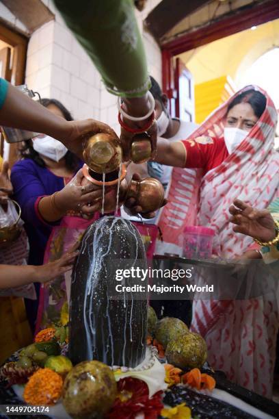 Hindu devotees offer prayers at a temple of Lord Shiva on the occasion of Maha Shivratri festival in Agartala. Agartala, Tripura.