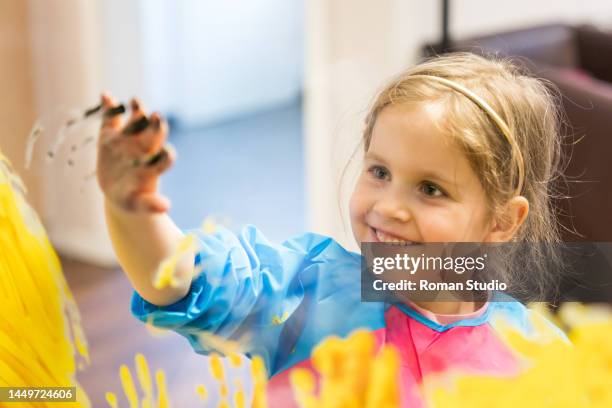finger painting. little girl doing art project. - rainbow kids stock-fotos und bilder