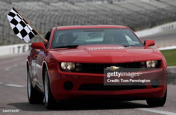 Northwest High School freshman Matt Boyd takes a victory lap with IZOD IndyCar Series driver James Hinchcliffe after Boyd won a 2012 Chevrolet Camaro...