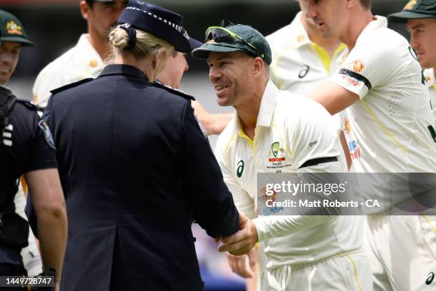 David Warner of Australia shakes hands with Police Commissioner Katarina Carroll APM as they pay their respects to Constable Matthew Arnold and...