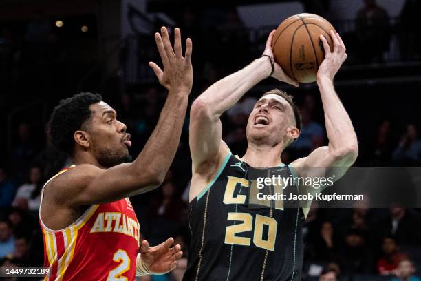 Gordon Hayward of the Charlotte Hornets shoots the ball while guarded by Trent Forrest of the Atlanta Hawks in the first quarter during their game at...