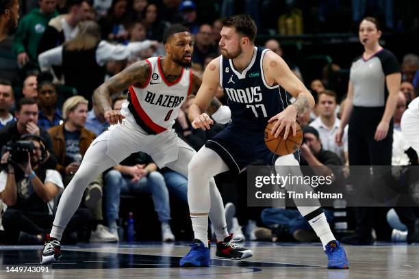 Luka Doncic of the Dallas Mavericks is guarded by Damian Lillard of the Portland Trail Blazers during the first quarter of the game at American...