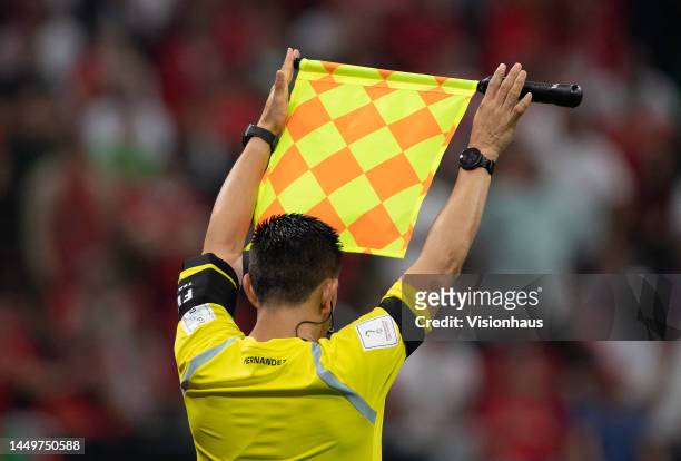 The Assistant Referee holds up his flag to signal an iminent substitution during the FIFA World Cup Qatar 2022 semi final match between France and...