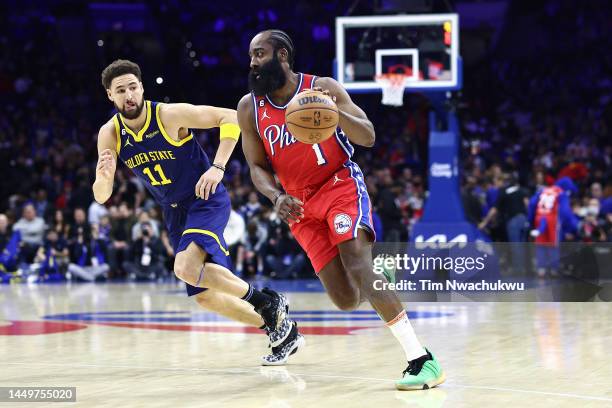 James Harden of the Philadelphia 76ers dribbles past Klay Thompson of the Golden State Warriors during the first quarter at Wells Fargo Center on...