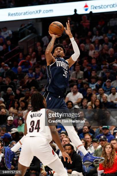 Christian Wood of the Dallas Mavericks shoots over Jabari Walker of the Portland Trail Blazers in the second half of the game at American Airlines...