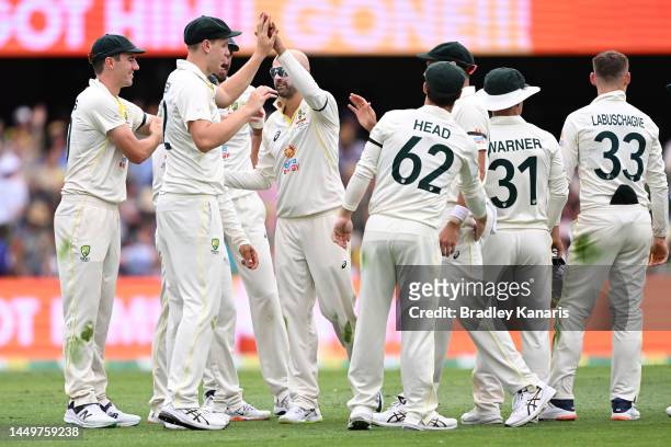 Nathan Lyon of Australia celebrates with Cameron Green of Australia after the wicket of Marco Jansen of South Africa for 2 runs during day one of the...