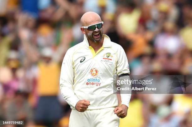 Nathan Lyon of Australia celebrates taking the wicket of Kyle Verreynne of South Africa for 64 runs during day one of the First Test match between...
