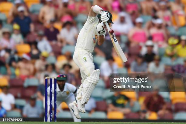 David Warner of Australia plays a shot and is caught by Khaya Zondo of South Africa for a duck during day one of the First Test match between...