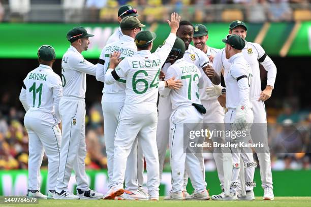 Kagiso Rabada of South Africa celebrates taking the wicket of David Warner of Australia for a duck during day one of the First Test match between...