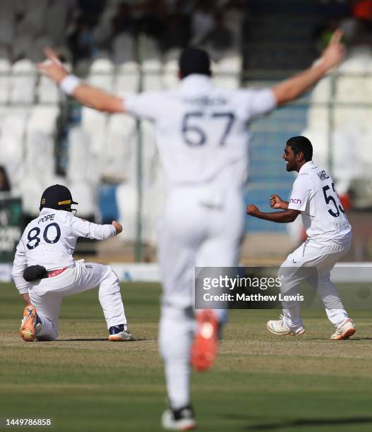 Rehan Ahmed of England celebrates the wicket of Saud Shakeel of Pakistan with Ollie Pope of England during day one of the Third Test match between...