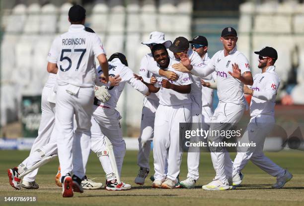 Rehan Ahmed of England is congratulated by team mates on the wicket of Saud Shakeel of Pakistan during day one of the Third Test match between...