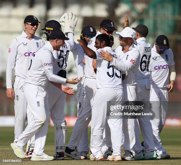 Rehan Ahmed of England is congratulated by team mates on the wicket of Saud Shakeel of Pakistan during day one of the Third Test match between...