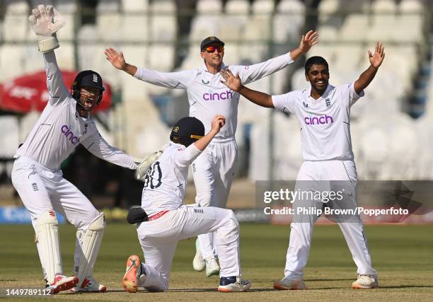 Rehan Ahmed , Ben Foakes, Ollie Pope and Joe Root of England celebrate after the dismissal of Saud Shakeel of Pakistan on the first day of the third...