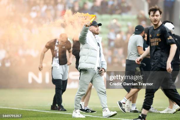 Fans storm the pitch in protest during the round eight A-League Men's match between Melbourne City and Melbourne Victory at AAMI Park, on December 17...