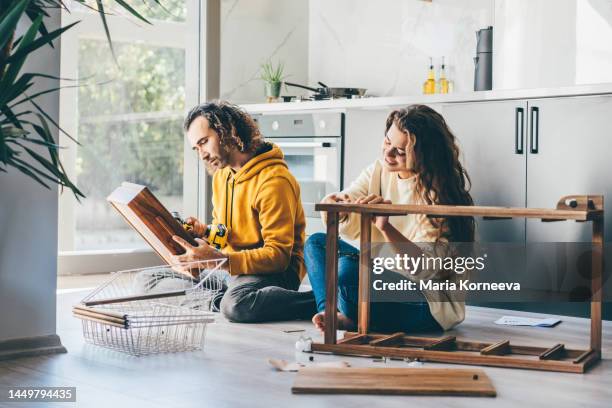 couple assembling furniture at home. - möbel stock-fotos und bilder