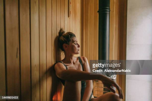young woman in the sauna - sauna wellness stock pictures, royalty-free photos & images