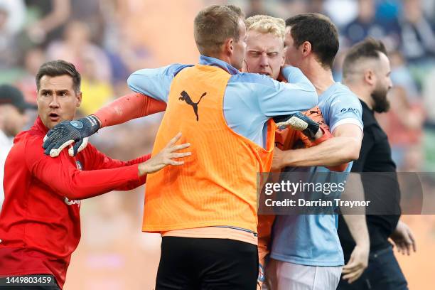 Bleeding Tom Glover of Melbourne City is escorted from the pitch by team mates after fans stormed the pitch during the round eight A-League Men's...